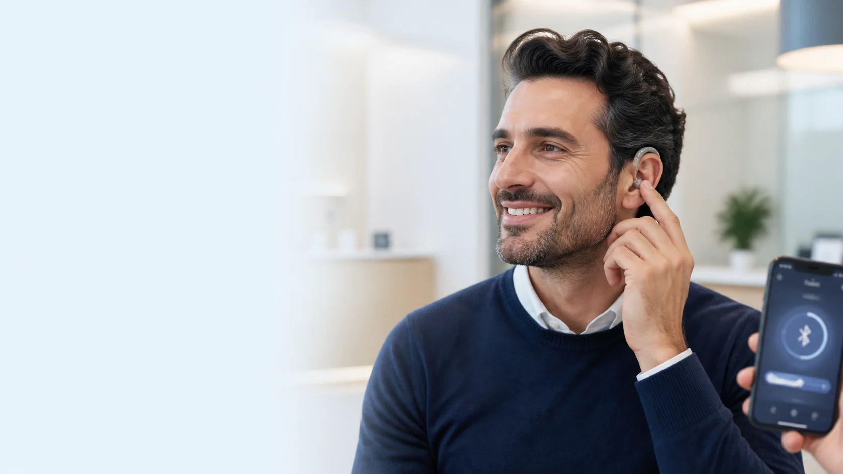 Telefon ve televizyonla Bluetooth bağlantılı işitme cihazı kullanan kişi
